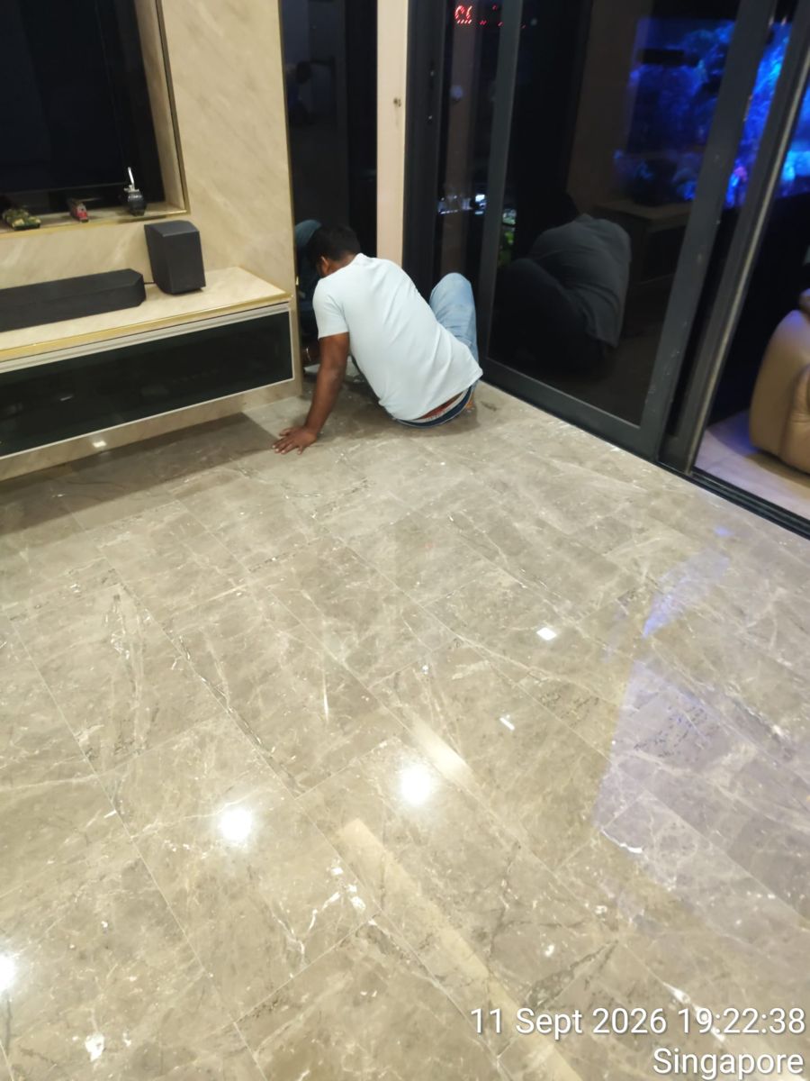 Technician touching up a marble floor by hand