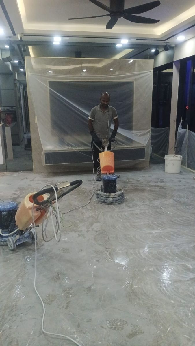 Floor machine honing a large marble living area